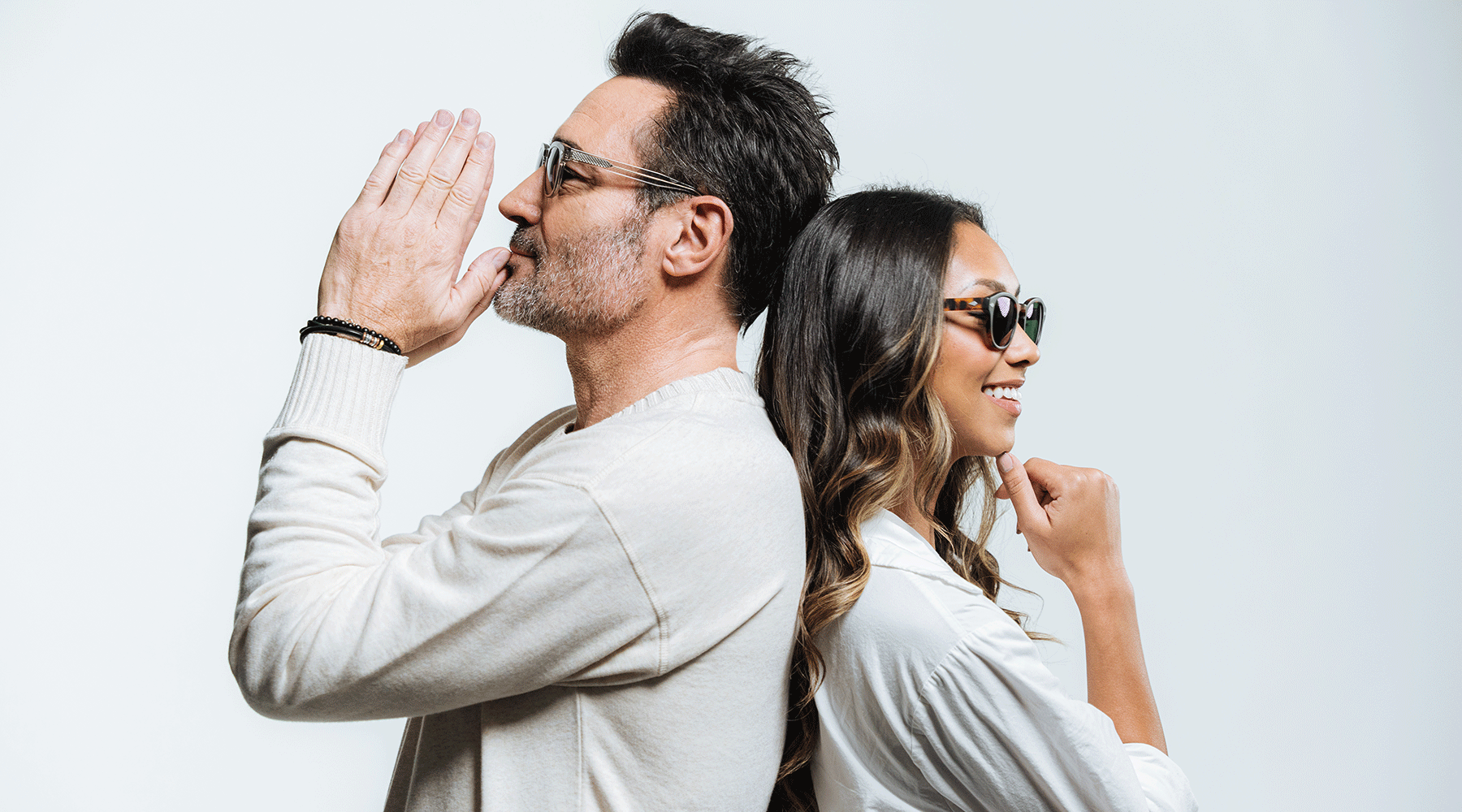 Man and woman wearing Alexander Daas Sunglasses with their backs against one another