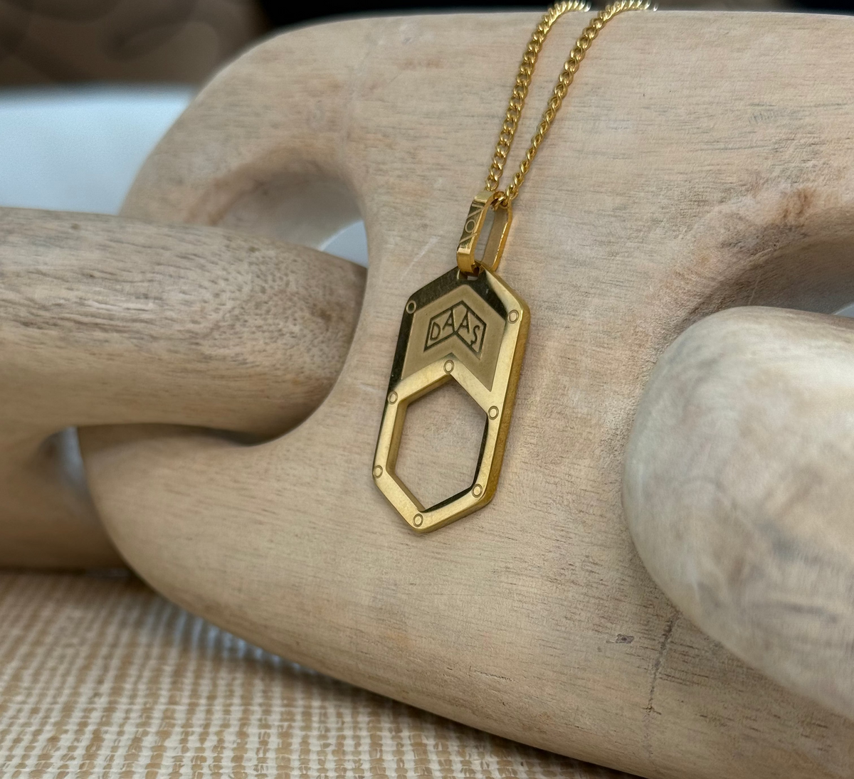 Alexander Daas Eyewear Chain The Roma in Gold hangin on top of a decoration.