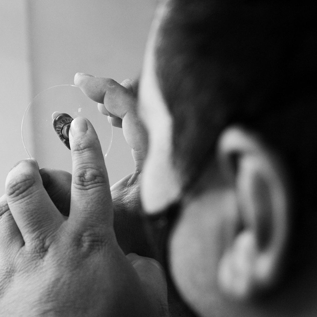 Optician testing eyeglass lenses