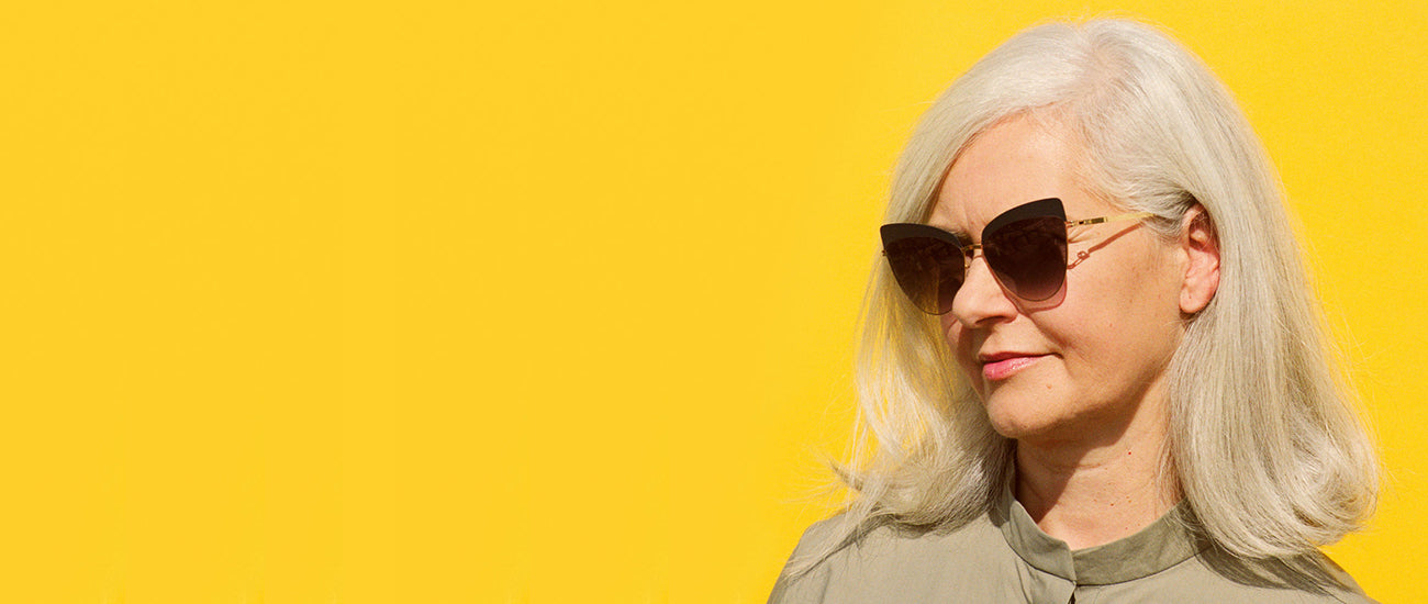 Woman wearing Alexander Daas Sunglasses on a yellow background